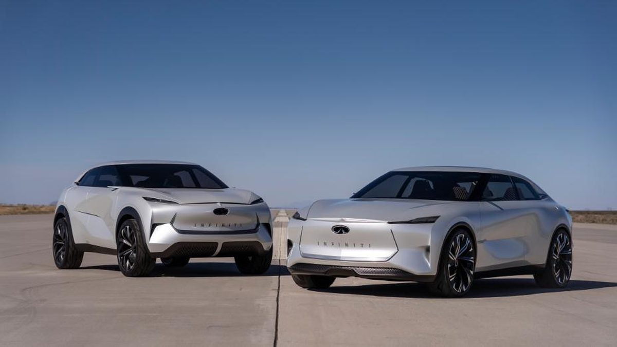 Two white INFINITI Inspiration concept cars, a crossover and a sedan, on an airfield